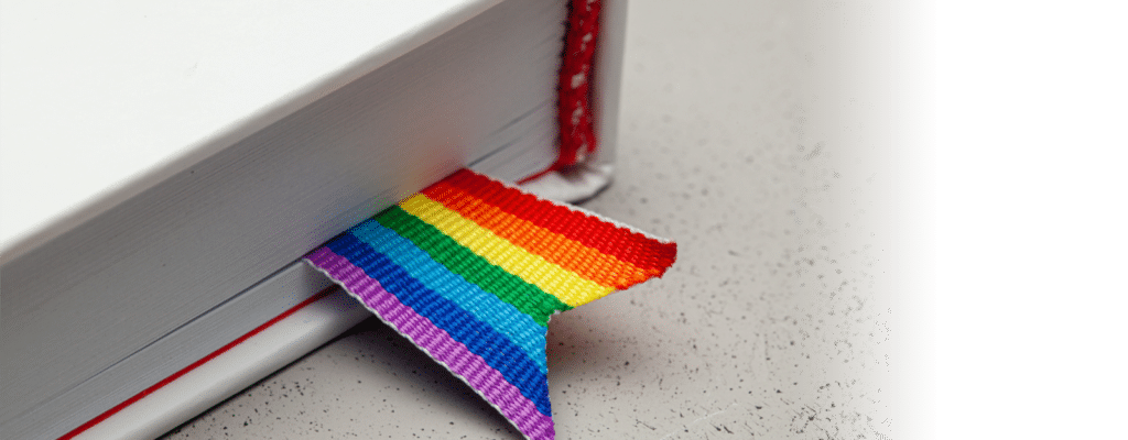 White book with a fabric rainbow bookmark