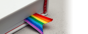 White book with a fabric rainbow bookmark