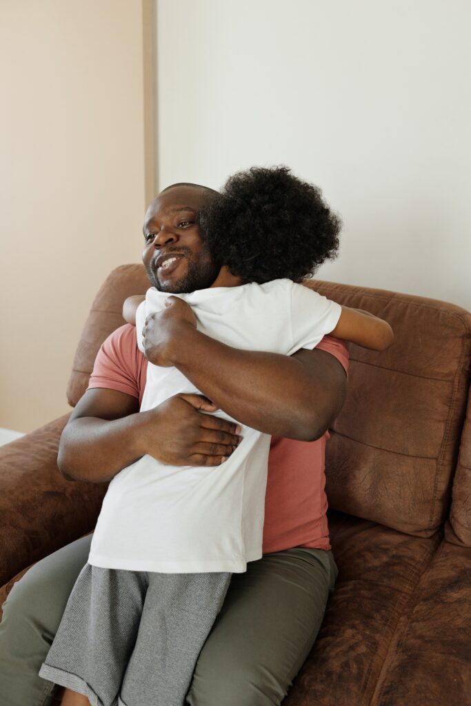 Dad hugging his child credit: CC August de Richelieu from Pexels