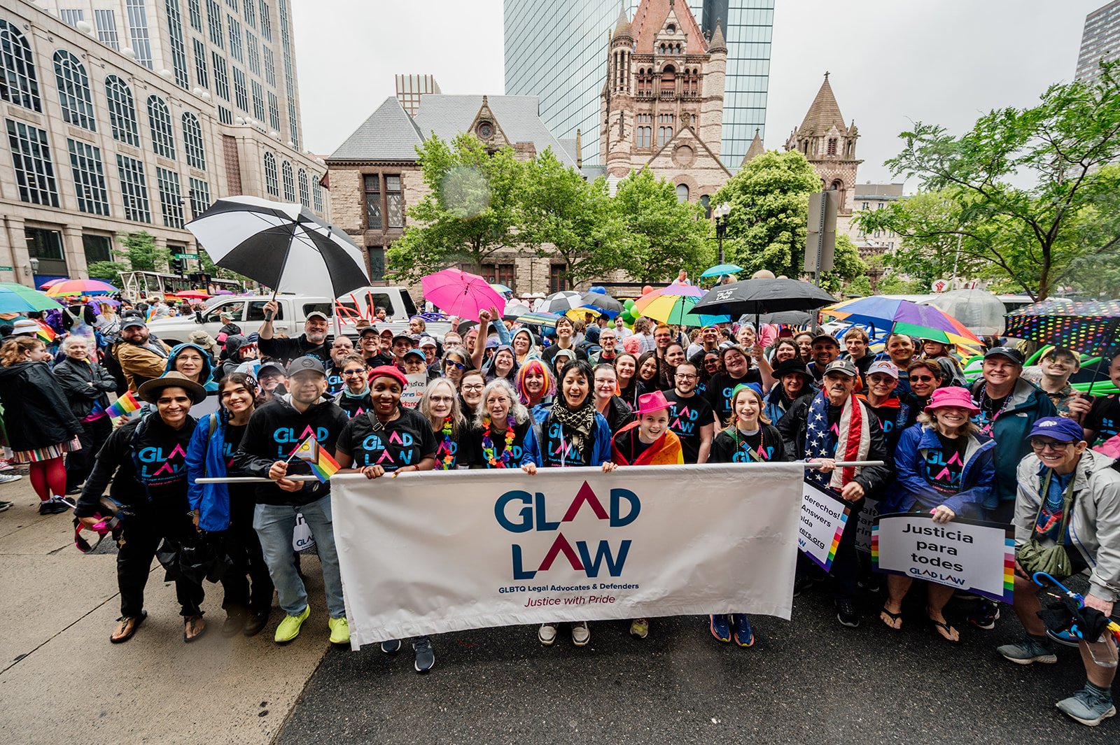 GLAD Law staff and supporter behind our banner at Boston Pride for the People