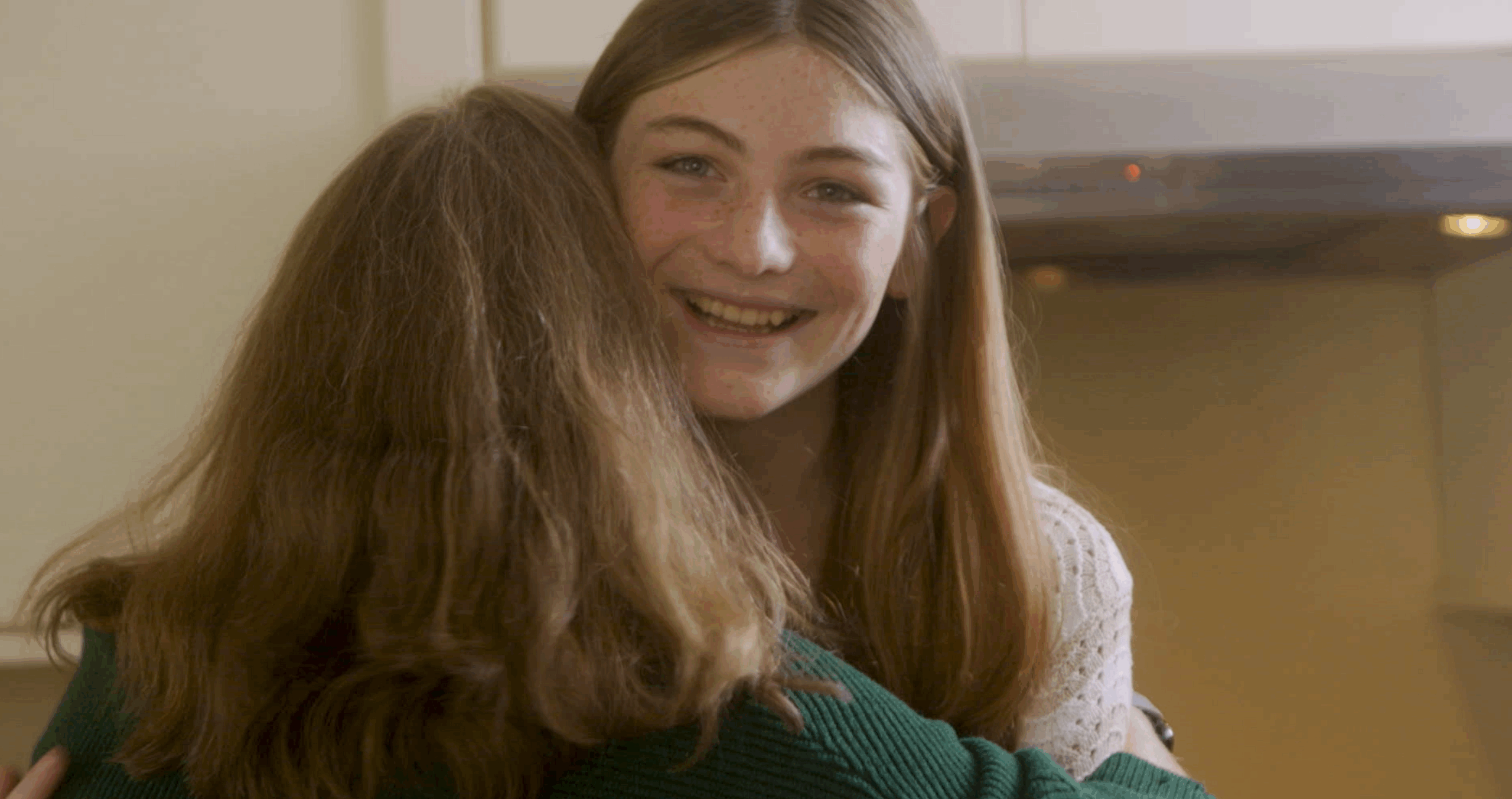 Teenage girl Parker and her mom Sara hugging