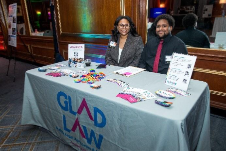 Braedyn and Kayden at an info table at formal event